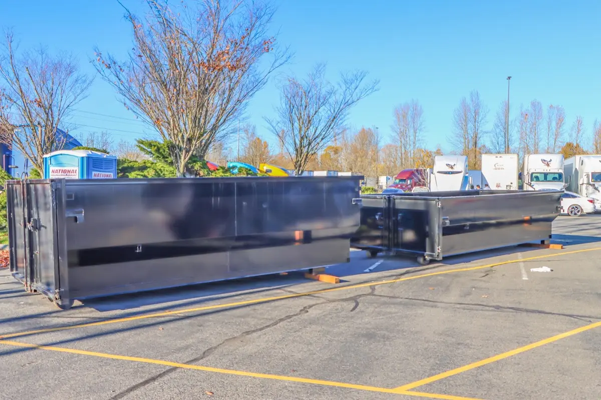 Professional dumpster rental service with roll-off container on residential driveway in Highland City